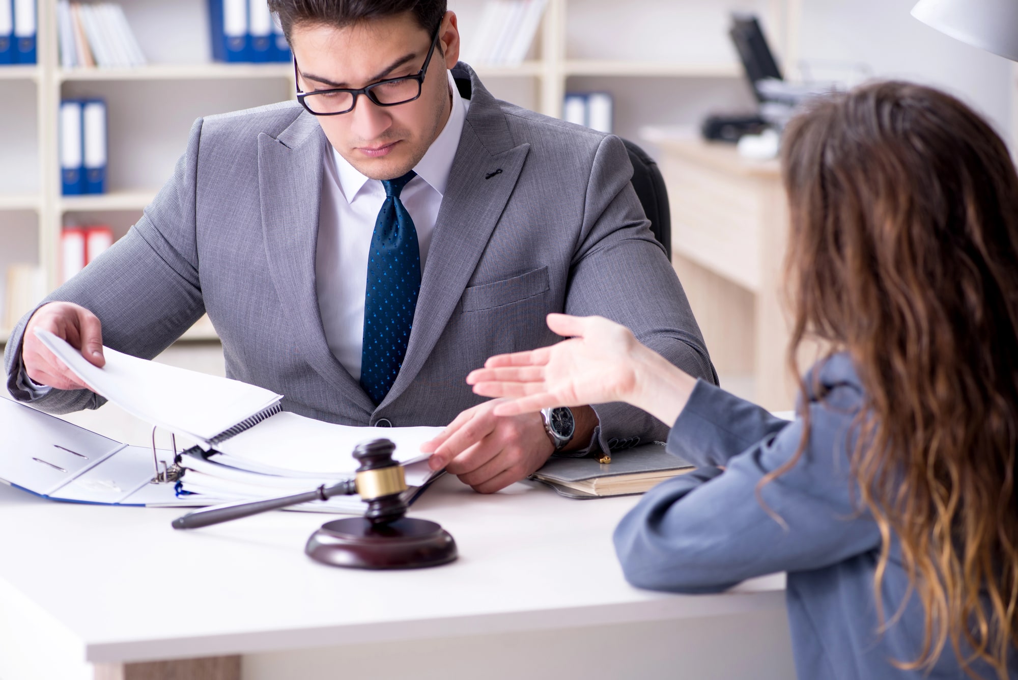 Attorney reviewing trust documents with client in office